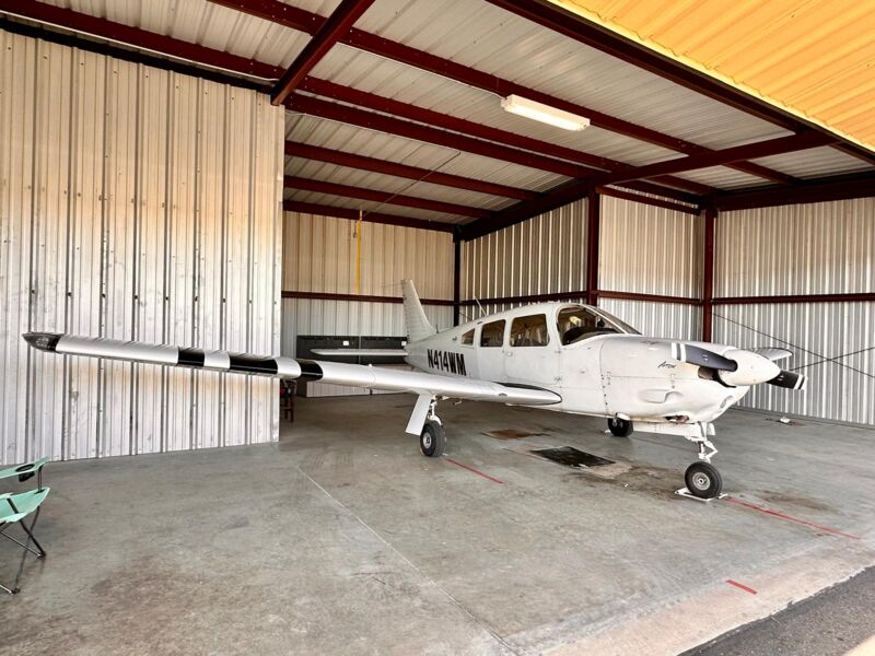 N414WM inside the club hangar, seen along the wing from the open hangar door
