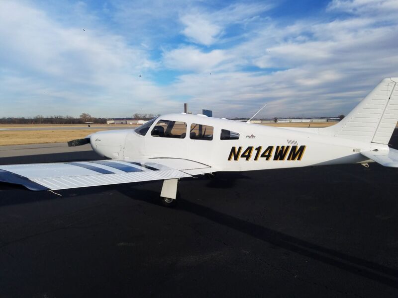 N414WM, the club's Piper Arrow III, parked on the ramp under a clear sky